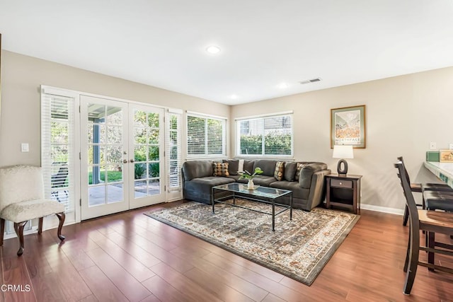 living room with hardwood / wood-style floors and french doors