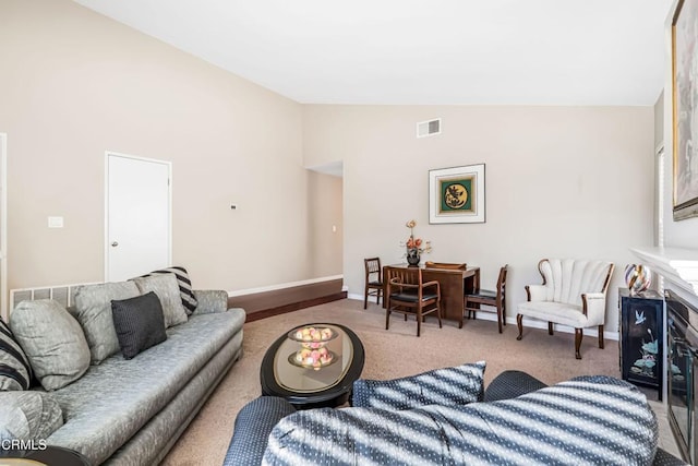 living room with vaulted ceiling and carpet