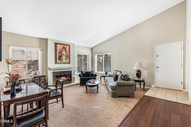 living room featuring wood-type flooring, a healthy amount of sunlight, and high vaulted ceiling