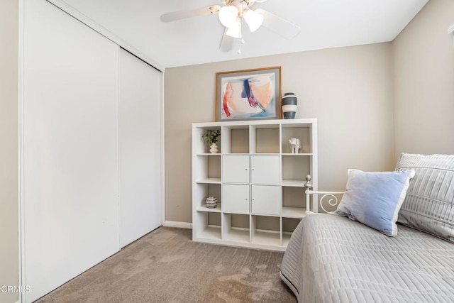 carpeted bedroom featuring a closet and ceiling fan