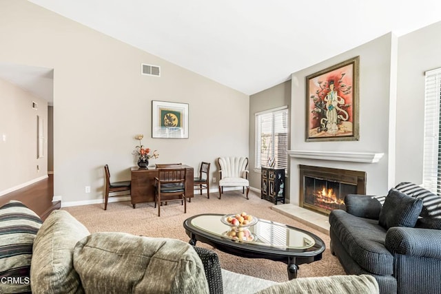 living room with light colored carpet and vaulted ceiling