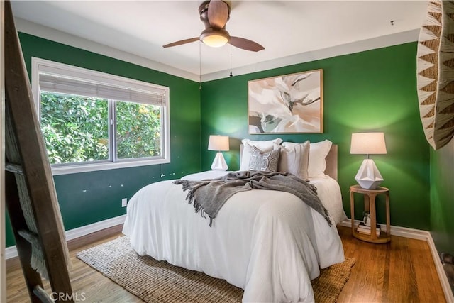 bedroom with wood-type flooring and ceiling fan