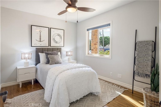 bedroom with ceiling fan and hardwood / wood-style floors