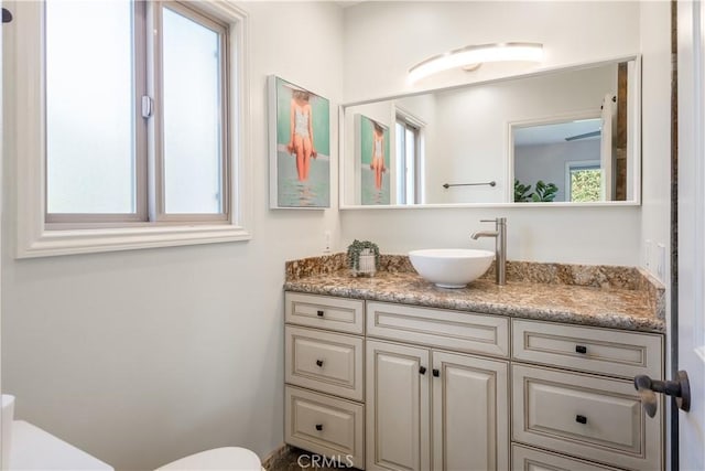 bathroom featuring vanity and toilet