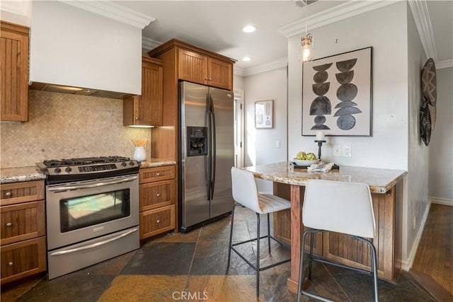 kitchen featuring decorative light fixtures, a kitchen breakfast bar, decorative backsplash, ornamental molding, and stainless steel appliances