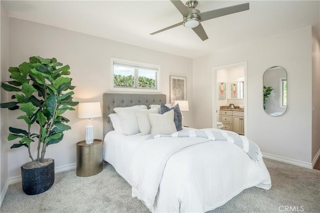 carpeted bedroom with ceiling fan and ensuite bath