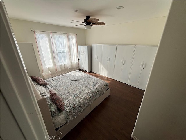 bedroom featuring dark hardwood / wood-style floors and ceiling fan