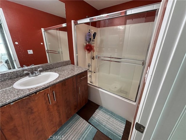 bathroom featuring vanity and shower / bath combination with glass door