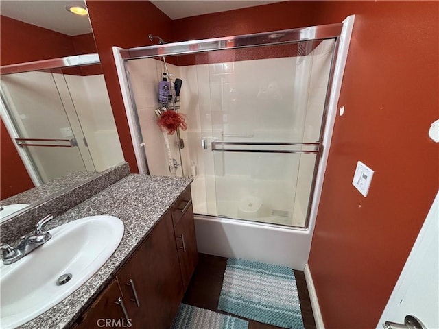 bathroom with vanity and combined bath / shower with glass door