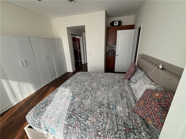 bedroom featuring dark hardwood / wood-style flooring