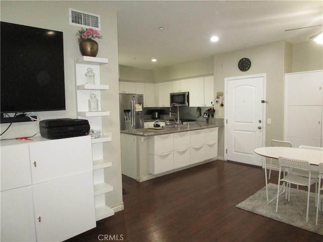 kitchen featuring sink, ceiling fan, white cabinetry, stainless steel appliances, and dark hardwood / wood-style floors