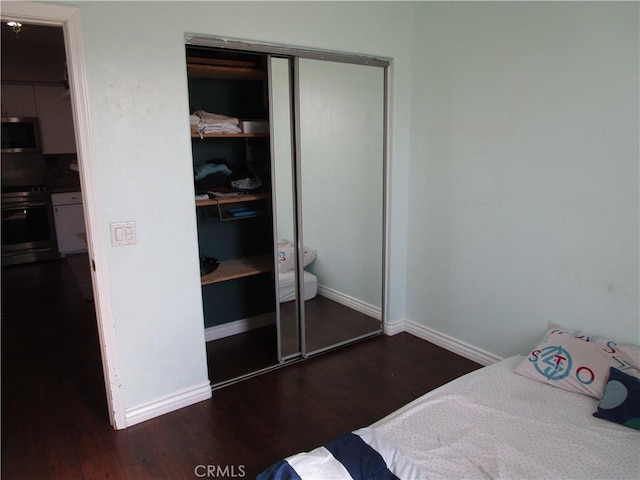 bedroom featuring dark hardwood / wood-style flooring and a closet