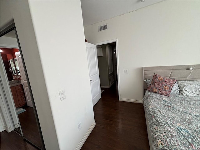 bedroom with dark hardwood / wood-style floors