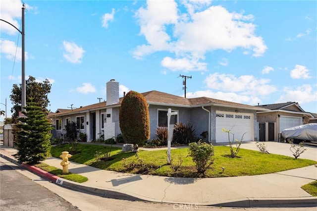 ranch-style home with a garage and a front lawn