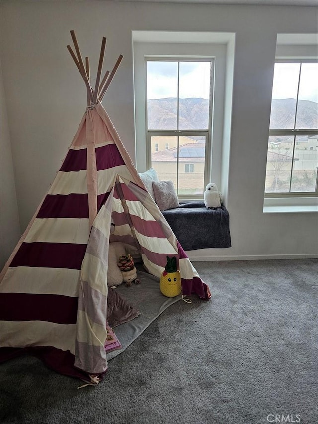 carpeted bedroom with a mountain view