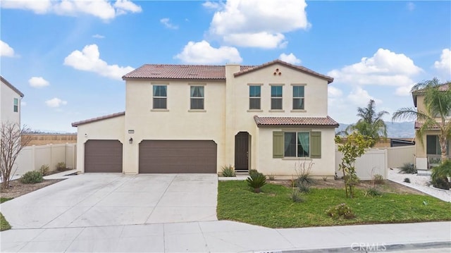 mediterranean / spanish-style house with a garage and a front yard