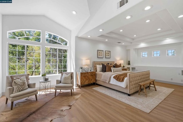 bedroom featuring high vaulted ceiling and light hardwood / wood-style floors