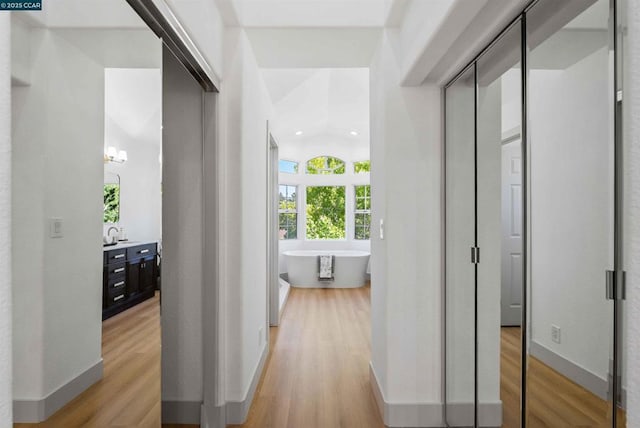 hallway with light hardwood / wood-style flooring