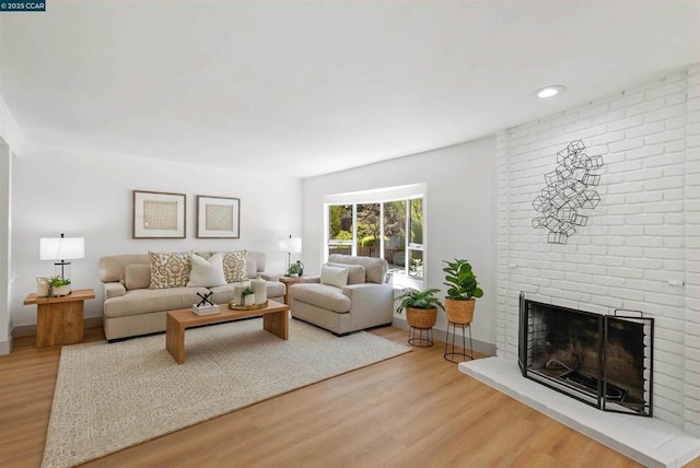 living room featuring hardwood / wood-style flooring and a fireplace