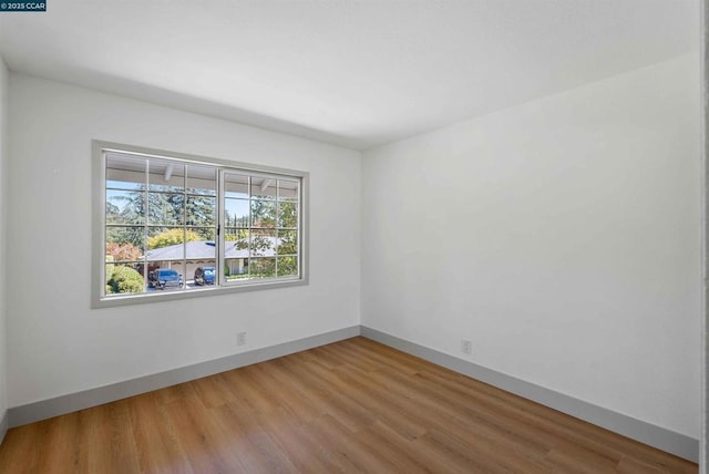 spare room with hardwood / wood-style flooring