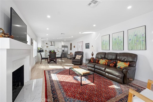 living room featuring a premium fireplace