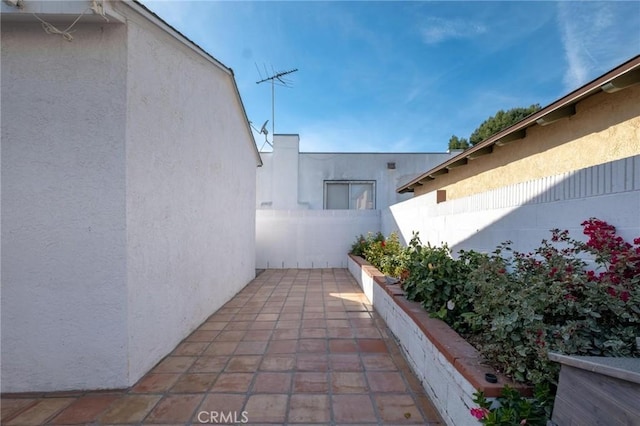 view of side of property featuring a patio area