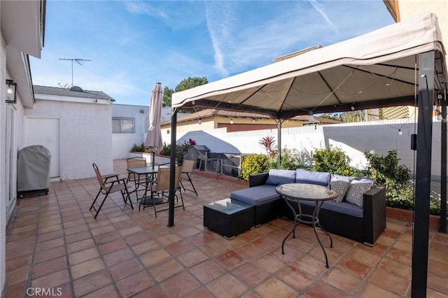 view of patio with area for grilling and an outdoor hangout area