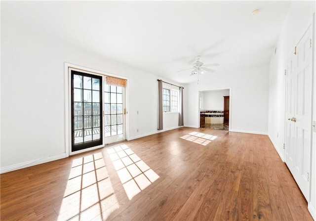 unfurnished living room featuring ceiling fan and light wood-type flooring