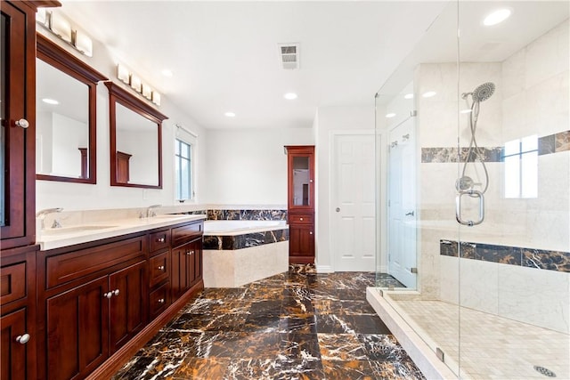 bathroom featuring vanity and shower with separate bathtub