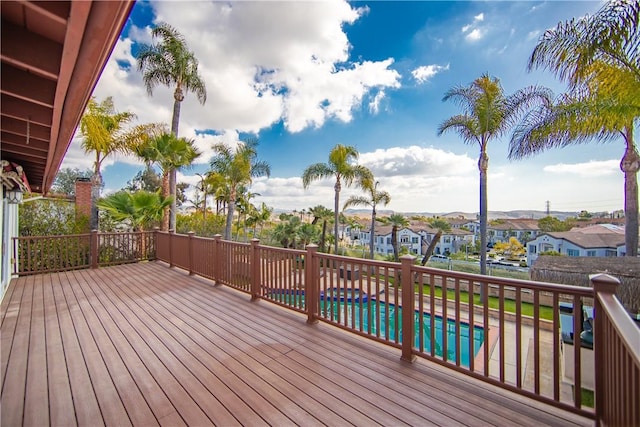 wooden terrace with a fenced in pool