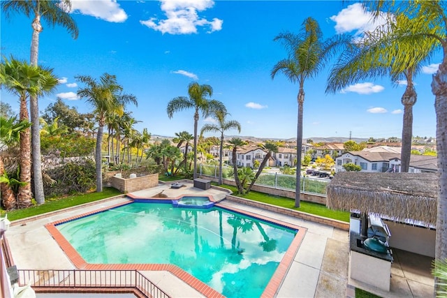 view of swimming pool featuring an in ground hot tub and a patio area