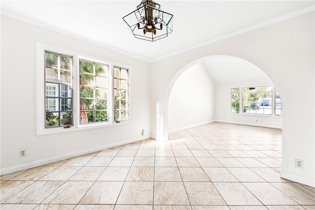 spare room with ornamental molding, light tile patterned floors, and a notable chandelier