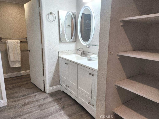 bathroom featuring vanity and hardwood / wood-style floors