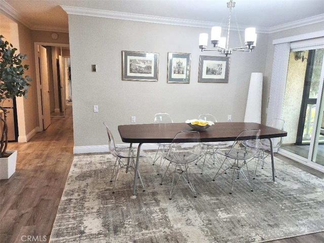 dining room featuring an inviting chandelier, hardwood / wood-style flooring, and ornamental molding