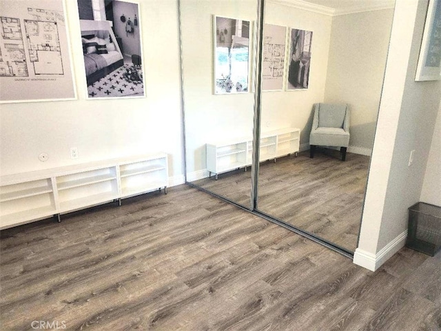 interior space featuring hardwood / wood-style floors and crown molding