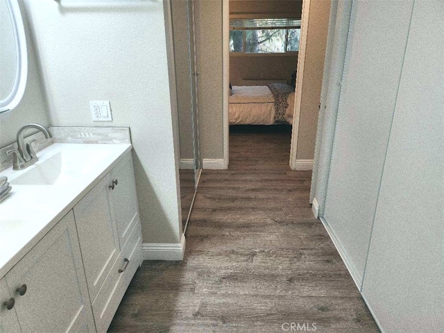 bathroom featuring vanity and hardwood / wood-style floors