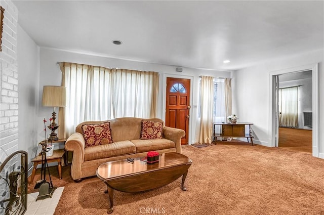 living room with light colored carpet and a fireplace