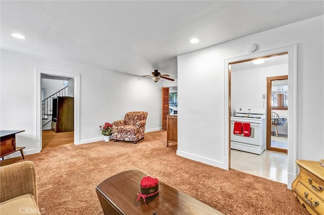 carpeted living room with ceiling fan