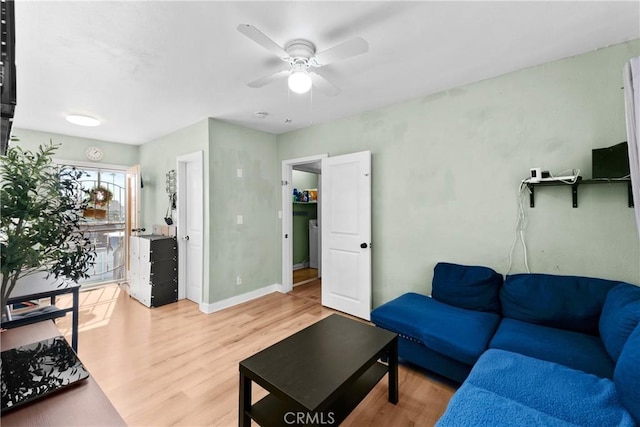 living room with ceiling fan, wood finished floors, and baseboards