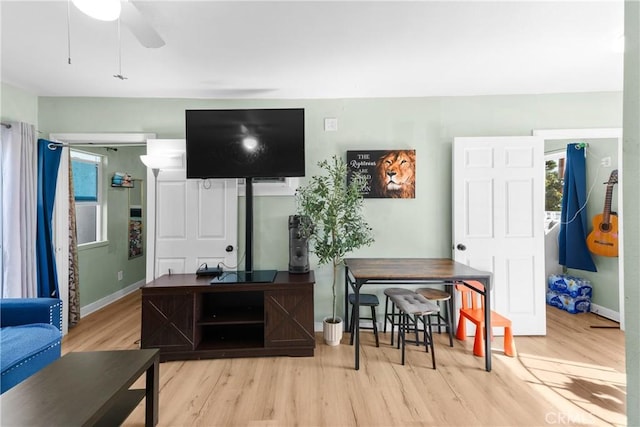 living room with ceiling fan and light hardwood / wood-style floors