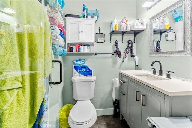 full bath with toilet, wood finished floors, vanity, baseboards, and an enclosed shower