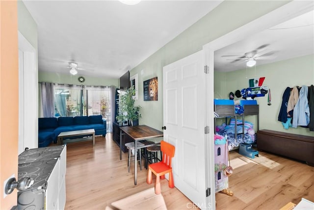 interior space featuring light wood-style floors and ceiling fan