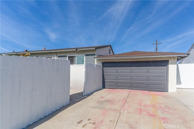 exterior space featuring a garage and fence