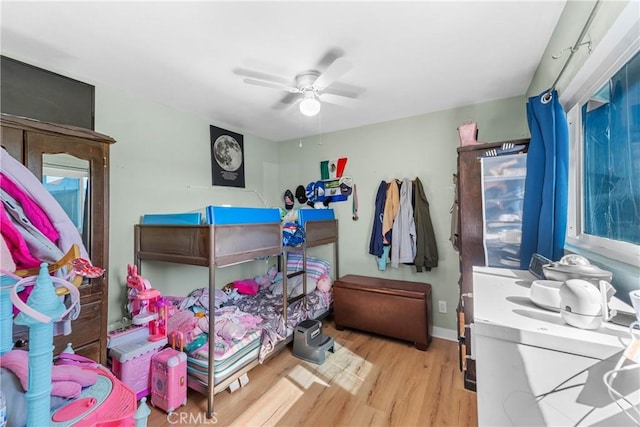 bedroom with ceiling fan and light wood-type flooring