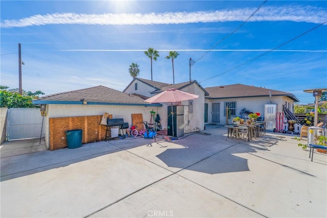 back of house featuring stucco siding, fence, and a patio