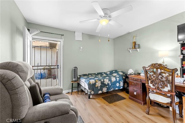 bedroom with baseboards, light wood-style flooring, and a ceiling fan