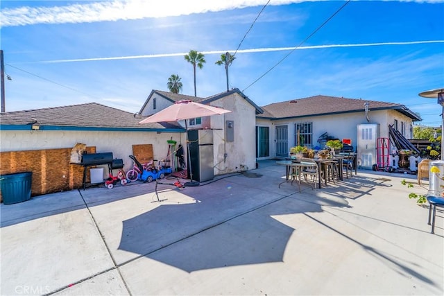 back of property featuring a patio area and stucco siding