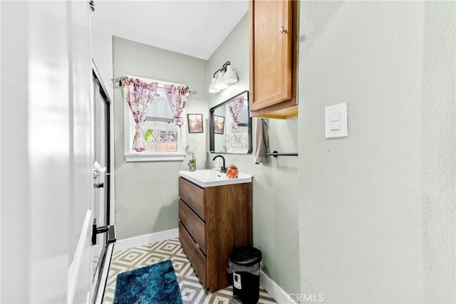 bathroom with baseboards, vanity, and tile patterned floors