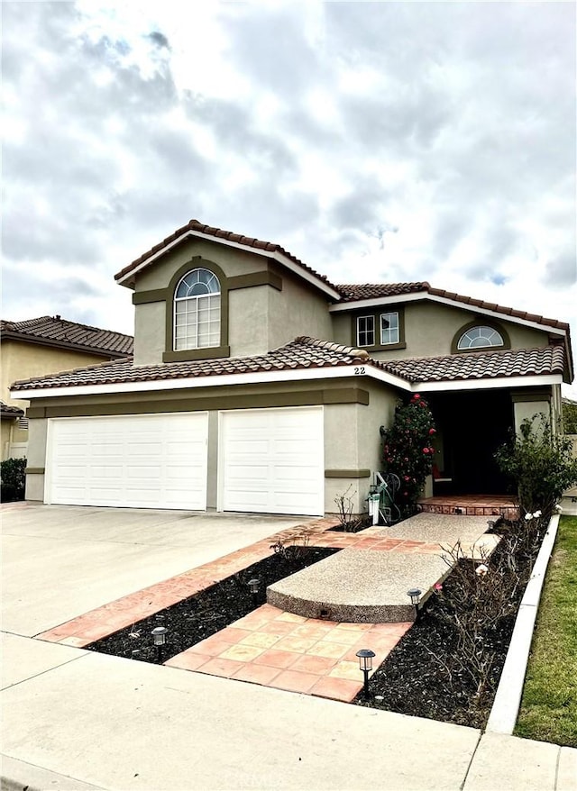 mediterranean / spanish home featuring a garage