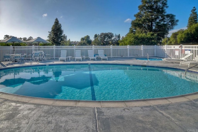 view of swimming pool featuring a community hot tub